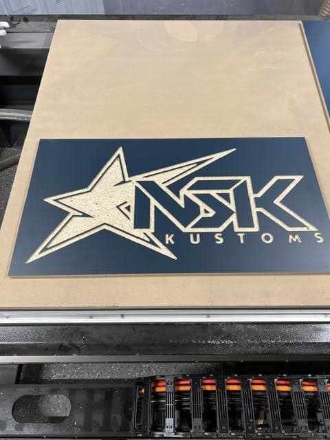 Custom CNC-cut NSK Kustoms sign on the router table
